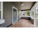 Inviting screened-in porch with tile flooring and a view of the front yard at 8912 Robey Dr, Indianapolis, IN 46234