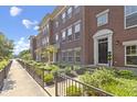 Brick townhome exterior with sidewalk access and manicured greenery at 9476 Oakley Dr, Indianapolis, IN 46260