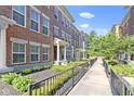 Row of brick townhomes with well-maintained landscaping and walkway at 9476 Oakley Dr, Indianapolis, IN 46260
