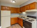 Well-lit kitchen with wooden cabinets, essential appliances, and plenty of countertop space at 951 W Mckay Rd, Shelbyville, IN 46176