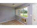 Bright living room featuring a large window offering plenty of natural light and grey walls at 951 W Mckay Rd, Shelbyville, IN 46176