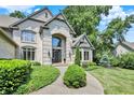 Elegant stone-clad home with well-maintained landscaping and a grand entrance, perfect for welcoming guests at 9690 Irishmans Run Ln, Zionsville, IN 46077