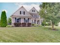 Attractive two-story home with manicured lawn, garden beds, brick accents, and neutral siding at 10107 Landis Blvd, Fishers, IN 46040