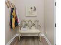 Cozy entryway nook with painted bench, a coat rack, and stylish flooring, creating an inviting space at 10725 Crum Ct, Fishers, IN 46037