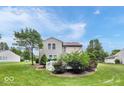 Spacious backyard with a deck, lush green grass, mature trees and landscaping at 1119 Albemarle Cir, Noblesville, IN 46062