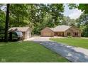 A charming home features a detached garage and RV parked on the driveway, surrounded by lush greenery at 1125 Observatory Rd, Martinsville, IN 46151