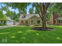Charming home with a lush green lawn and beautiful trees at 1149 E 56Th St, Indianapolis, IN 46220