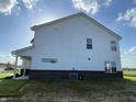 The back exterior reveals modern siding and a well-designed layout with clean lines and a brick foundation at 1256 Little Rodeo Pl, Greenwood, IN 46143