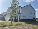 This well-manicured two-story home features sleek vinyl siding, brick foundation, and a spacious front yard at 1256 Little Rodeo Pl, Greenwood, IN 46143