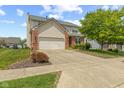 Charming two-story home with a well-manicured lawn, brick accents, and an attached two-car garage at 1260 Easton Point Dr, Greenwood, IN 46142