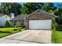 Attractive single-story brick home with an attached two-car garage, neat landscaping, and a concrete driveway at 12922 St Andrews Way, Fishers, IN 46038