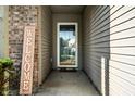 Inviting front porch view featuring a 'Welcome' sign near the front door at 12922 St Andrews Way, Fishers, IN 46038