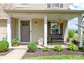 Welcoming front porch features stylish decor, a comfortable bench, and potted plants, enhancing the home's curb appeal at 14754 Drayton Dr, Noblesville, IN 46062