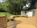 Expansive wood deck showcasing built-in bench seating and a view of the lush, green backyard at 1738 E 71St St, Indianapolis, IN 46220