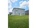 Spacious backyard featuring lush green grass and a view of the home's rear exterior at 1932 Downey Ln, Greenfield, IN 46140