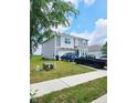 Well-maintained two-story home with an attached garage, grassy front lawn, and sidewalk at 1932 Downey Ln, Greenfield, IN 46140