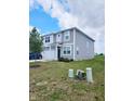 Two-story home with gray siding, a well-kept lawn, and a two-car attached garage at 1932 Downey Ln, Greenfield, IN 46140