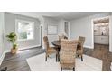 Cozy dining area with a round table, woven chairs, and natural light, perfect for intimate meals at 209 Howard Ave, Arcadia, IN 46030