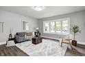 Bright living room boasts new floors, large window, and modern decor with a cozy atmosphere at 209 Howard Ave, Arcadia, IN 46030