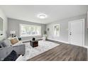 Bright living room boasts new floors, large window, and modern decor with a cozy atmosphere at 209 Howard Ave, Arcadia, IN 46030