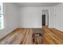 Bright living room with hardwood floors, white walls, and a doorway leading to another room at 2400 Walnut St, Anderson, IN 46016