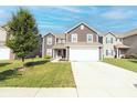 Two-story home featuring a two-car garage, green lawn, and blue sky at 2550 Cedarmill Dr, Franklin, IN 46131