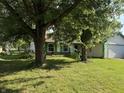 Well-maintained home featuring mature trees and a lush green lawn at 3309 Wedgewood Dr, Indianapolis, IN 46227