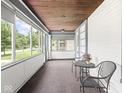 Enclosed front porch with large windows offering plenty of natural light at 3936 Graceland Ave, Indianapolis, IN 46208