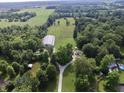 Picturesque aerial shot showcasing the property's layout, including the buildings, driveway, and lush surroundings at 3942 Senour Rd, Indianapolis, IN 46239