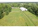Large manicured property with white fences and various trees, including a home and barn at 3942 Senour Rd, Indianapolis, IN 46239