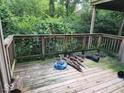 View of an outdoor wooden deck surrounded by lush greenery at 4235 Foxglove Trce, Indianapolis, IN 46237