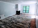Spacious living room with fireplace and large window, ready for renovation at 4235 Foxglove Trce, Indianapolis, IN 46237