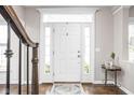 Bright foyer featuring a white front door with sidelights and a decorative rug at 4415 Summer Dr, Zionsville, IN 46077