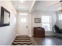 Inviting entryway with wood-look flooring, ample natural light, and a decorative rug at 485 Washington St, Fortville, IN 46040