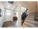 Bright foyer with a staircase, light gray floors, and an open layout at 485 Washington St, Fortville, IN 46040