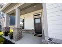 Inviting front porch with brick accents, stylish pillars, and a welcoming entrance at 485 Washington St, Fortville, IN 46040
