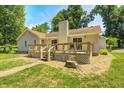 Backyard wooden deck perfect for entertaining, with a lush lawn and mature trees at 494 W Greencastle Rd, Mooresville, IN 46158