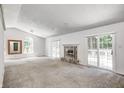 Bright living room with cozy fireplace and natural light from sliding glass doors at 494 W Greencastle Rd, Mooresville, IN 46158