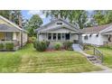 Charming bungalow with a well-maintained front yard, shrubbery, and inviting front entry at 5209 E North St, Indianapolis, IN 46219