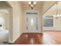 Bright foyer with hardwood floors and elegant chandelier at 5220 Orahood Ct, Plainfield, IN 46168