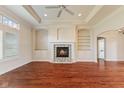 Spacious living room with a stone fireplace and built-in shelving at 5220 Orahood Ct, Plainfield, IN 46168