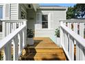 Inviting front porch with wooden deck and potted plants for a warm welcome at 5312 Norwaldo Ave, Indianapolis, IN 46220