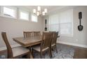 Dining room with hardwood flooring and natural light from the adjacent windows at 5351 Rose Dr, Zionsville, IN 46077