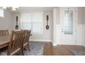 Dining room with light-colored walls, wood floors, and window with natural light at 5351 Rose Dr, Zionsville, IN 46077