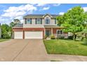 Charming two-story home with brick accents, green shutters, and a well-manicured lawn at 6045 Copeland Mills Ct, Indianapolis, IN 46221