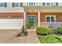Close-up of front porch with brick siding and a decorative wreath on the teal front door at 6045 Copeland Mills Ct, Indianapolis, IN 46221