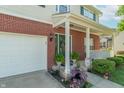 Charming covered porch with colorful flower arrangements and inviting decor at 6045 Copeland Mills Ct, Indianapolis, IN 46221