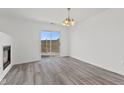 Bright dining area with sliding glass doors and contemporary chandelier lighting at 618 Stobus Dr, Greenwood, IN 46143
