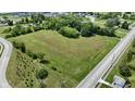 Aerial view of a large plot of land surrounded by mature trees and a pond ready to build your dream home at 6637 E County Road 600 S, Plainfield, IN 46168