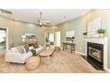Spacious living room with a fireplace, plush carpet, and neutral decor at 6656 Easy St, Fishers, IN 46038